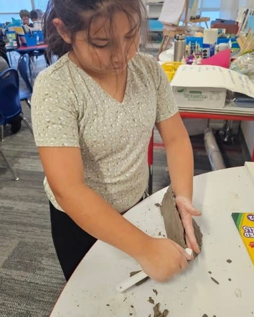 A TriPoint student working with clay in the classroom studio.